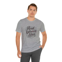 Load image into Gallery viewer, Read Between the Lines T-Shirt — Literary Quote Graphic Tee for Book Lovers