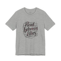 Load image into Gallery viewer, Read Between the Lines T-Shirt — Literary Quote Graphic Tee for Book Lovers