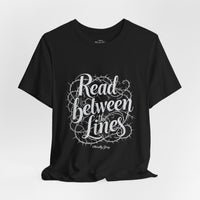Load image into Gallery viewer, Read Between the Lines T-Shirt — Gothic Script Graphic Tee